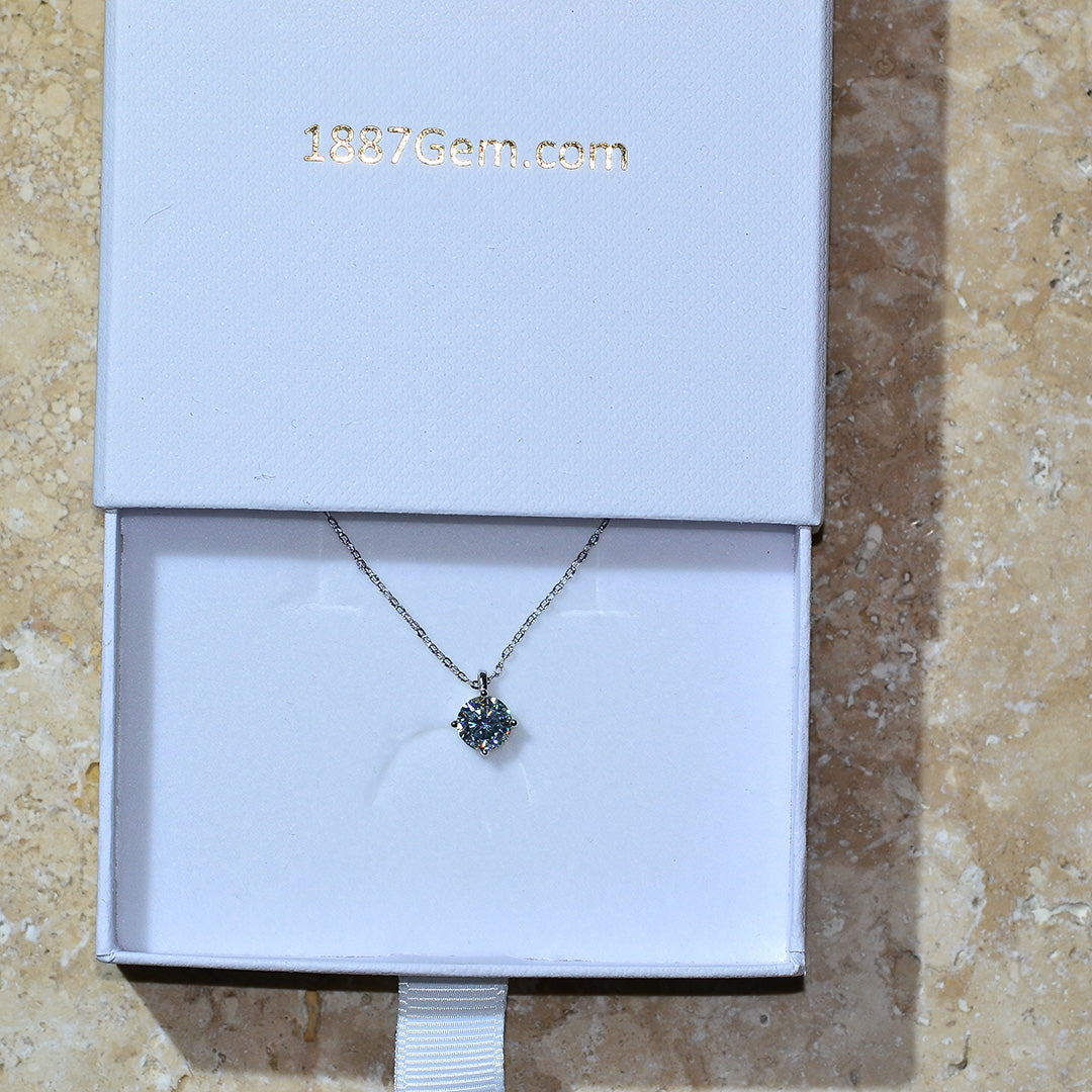 Eine Schmuck Silberkette mit einem Diamant Anhänger in einer Geschenk Verpackung.